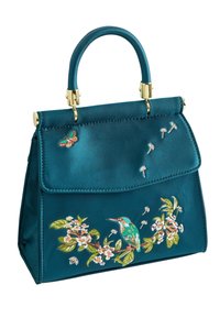 Turkizna satenska torbica z zlatimi dodatki, ki se ponaša z zapletenim vezenjem cvetja in ptic spredaj ter strukturirano obliko.