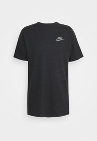 Black cotton T-shirt featuring short sleeves and a round neckline, with a small white Nike logo on the left chest area.