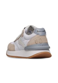 White and beige sneaker with suede and synthetic panels, lace-up design, gray accents, rear logo detail, and a rubber sole.