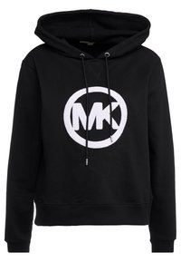 Felpa nera con cappuccio, dotata di un logo circolare bianco "MK" al centro, con cappuccio regolabile tramite cordini e polsini a coste. Realizzata in un tessuto testurizzato.