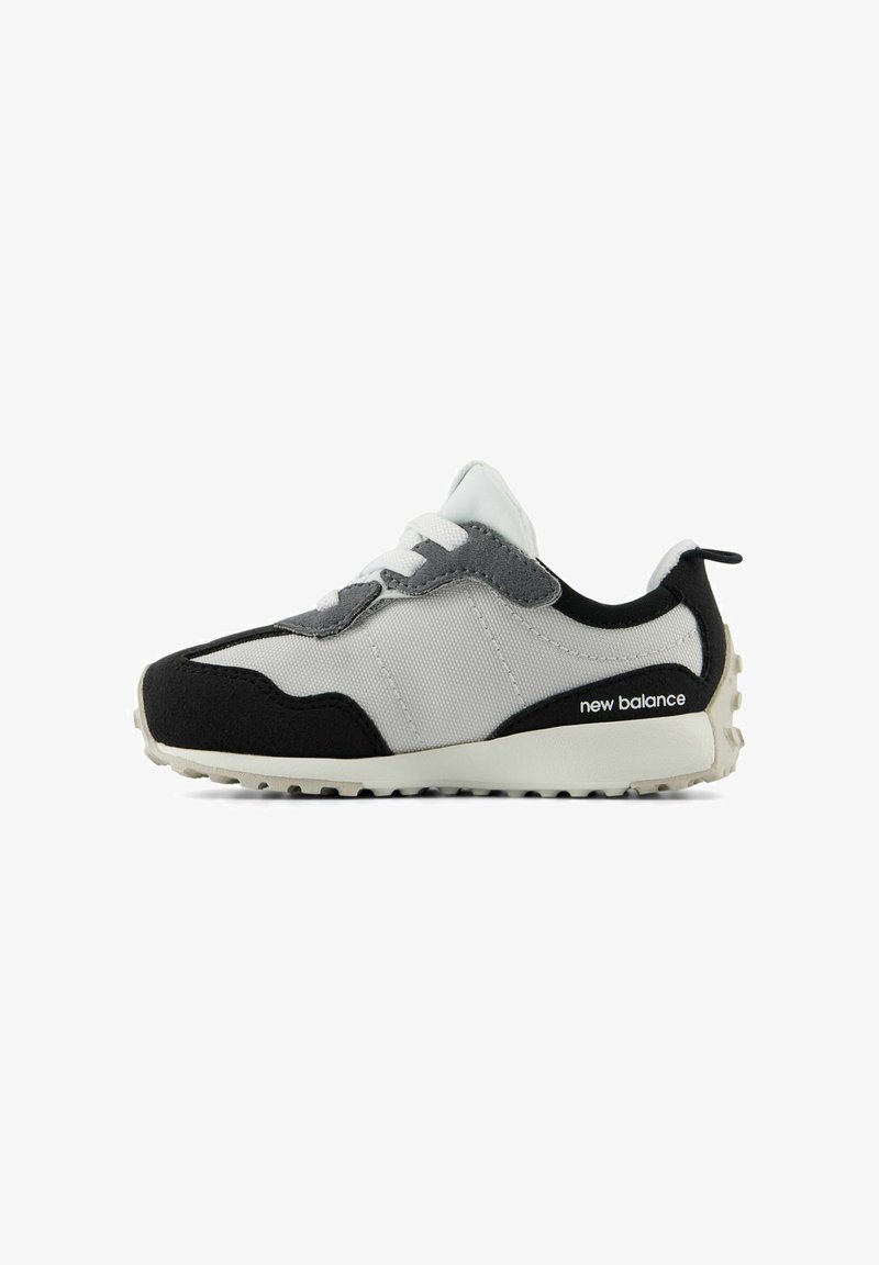 Sneaker with a black, gray, and white color scheme; features a fabric upper, suede accents, white laces, and a textured rubber sole.