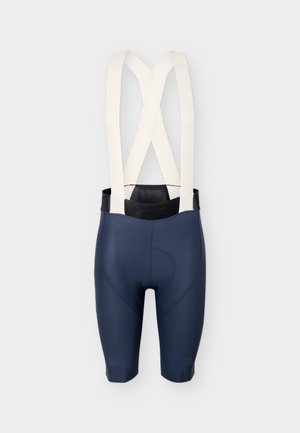 Marineblaue Radhose mit gepolstertem Sitz und breiten weißen elastischen Trägern, die sich am Rücken kreuzen.