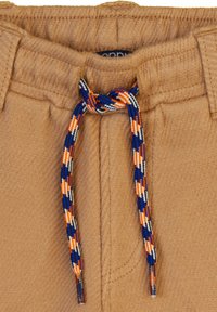 Lichtbruine sweatpants met een elastische tailleband, voorzien van een multicolor gevlochten koord in blauwe, oranje en witte patronen.