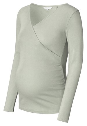 Langarmige zwangerschapsblouse van zachte ribstof, in een lichtgroene kleur en met een crossover ontwerp en zijrimpeling voor een aansluitende pasvorm.