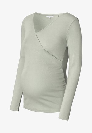 Langarmige zwangerschapsblouse van zachte ribstof, in een lichtgroene kleur en met een crossover ontwerp en zijrimpeling voor een aansluitende pasvorm.