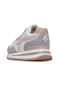 Gray and white sneaker with pink accents; features mesh and suede materials, textured heel, and a glittery gold back. Hexagonal sole pattern.