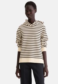 Gestreepte hoodie in crème en donkerbruin, met een trekkoordkap en geribbelde manchetten. Gemaakt van zachte, textuurrijke stof met een relaxte pasvorm.