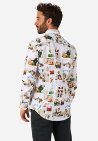 White shirt featuring a collage of photographed scenes. Long sleeves with button cuffs, lightweight fabric, and a relaxed fit.