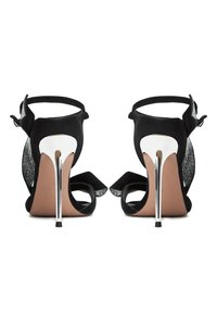 Black high-heeled sandals with satin straps and a metallic heel, featuring lace panels and bow accents at the front and ankle.