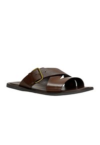 Brown leather slide sandals with an adjustable strap featuring a textured surface and a brass buckle, open toe design, flat sole.