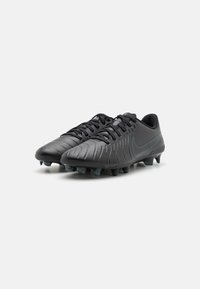 Black football boots with textured synthetic material, lace-up design, and molded cleats. Features a subtle logo and a streamlined silhouette.