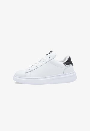 White leather sneaker with a smooth texture, round toe, and white laces. Features a black heel tab and a white rubber sole for grip.