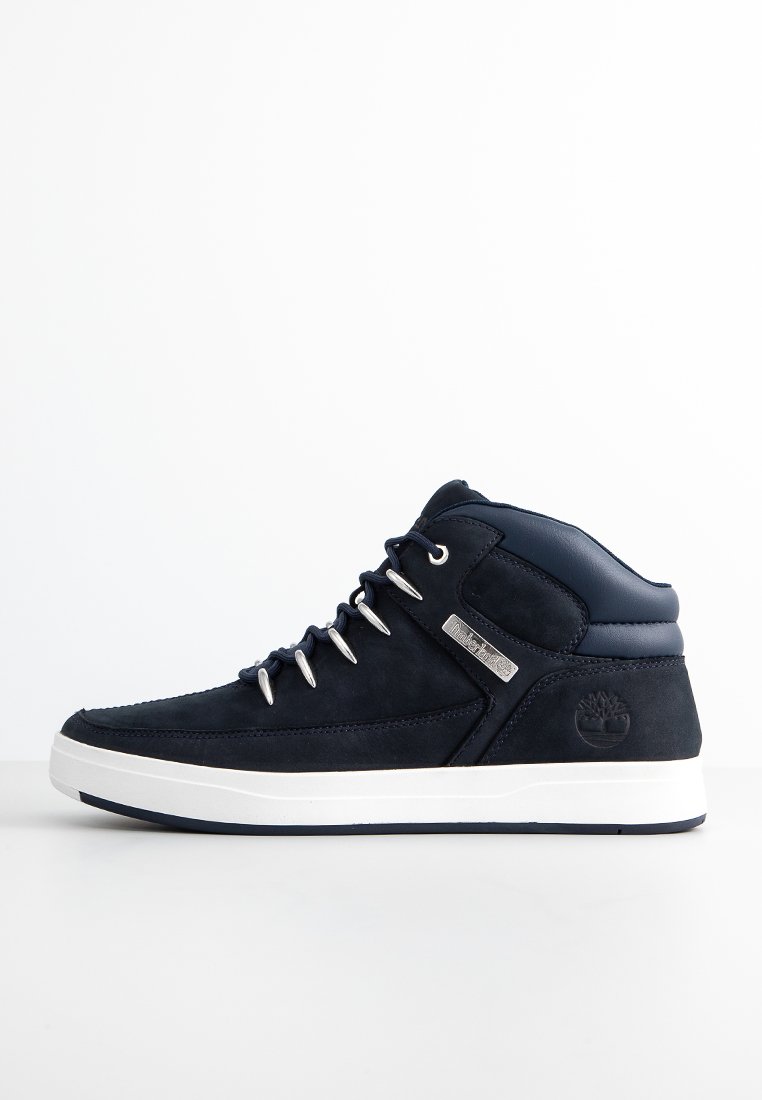 Sneaker alta in suede blu navy con suola bianca, caratterizzata da occhielli in argento, collo imbottito e dettaglio del logo sul lato.