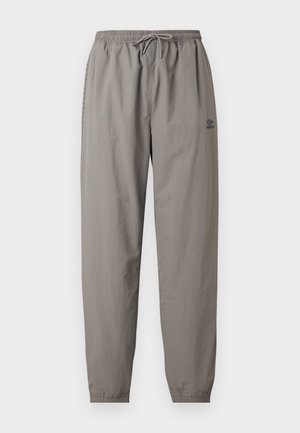 Light gray casual pants with elastic waistband, drawstring, elastic cuffs, and a small Umbro logo on the right thigh.