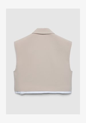 Beige bauchfreies Weste mit glatter Textur, ausgestattet mit einem klassischen Kragen und weißem Saum, zeigt ein minimalistisches Design.