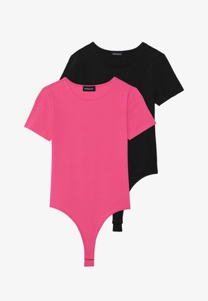 Two bodysuits: one pink and one black. Both feature short sleeves, a round neckline, and a thong bottom with snap closures.