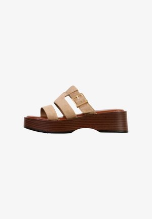 Beige suede wedge sandal with two straps, gold buckle on top strap, and wooden textured platform sole.