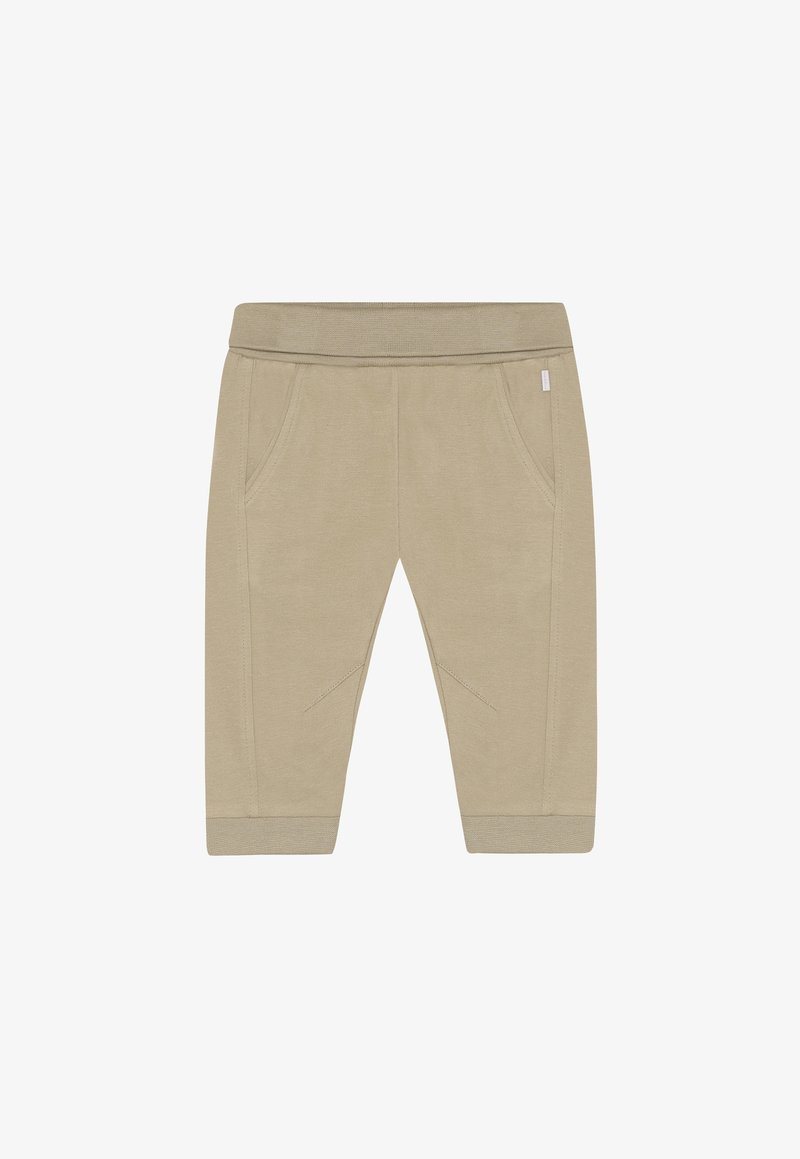 Pantalon de jogging beige en coton avec une taille élastique et des poches latérales. Présente des accents texturés aux genoux et des poignets côtelés aux chevilles.