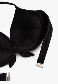 Bra imbottito nero con tessuto liscio, spalline regolabili e chiusura con gancio metallico. Presenta un design senza cuciture e una texture morbida all'interno delle coppe.