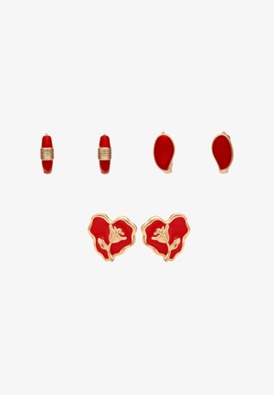 Trzy pary czerwono-złotych kolczyków: małe koła z złotymi paskami, owalne czerwone wkrętki z złotymi krawędziami oraz czerwone wkrętki w kształcie serca ze złotymi kwiatowymi zdobieniami.