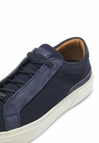 Navy mesh and suede sneaker with a white rubber sole, contrasting tan interior, and lace-up closure featuring metal eyelets.