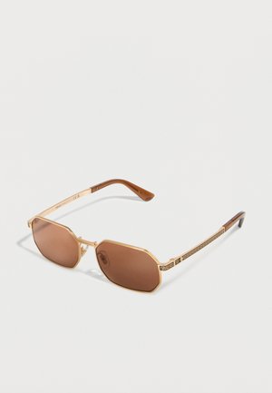 Gold-framed, hexagonal brown-lens sunglasses with patterned arms and brown ear tips on a white background.