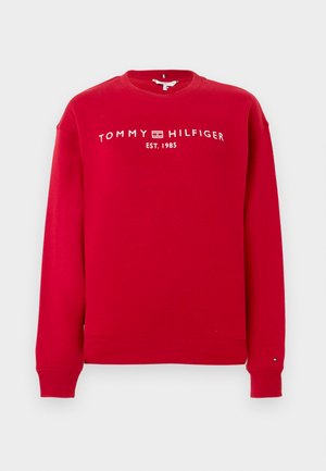 Sweatshirt en coton rouge à manches longues, col rond, avec des poignets et un ourlet côtelés, affichant le texte blanc "TOMMY HILFIGER EST. 1985".