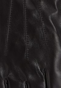 Black leather gloves with a textured finish, featuring prominent stitching and finger openings, showcasing a sleek and minimalist design.