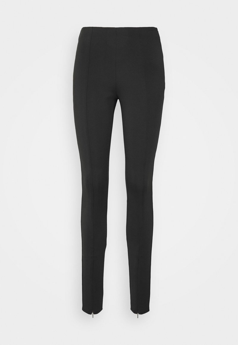 Pantalon noir slim fit à taille haute avec zips aux chevilles, présenté sur un fond clair uni.