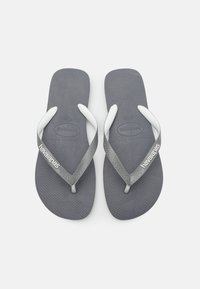 Chinelos de borracha cinza com tiras brancas, apresentando um suporte texturizado e logótipo da marca. Design clássico e plano, adequado para uso casual.