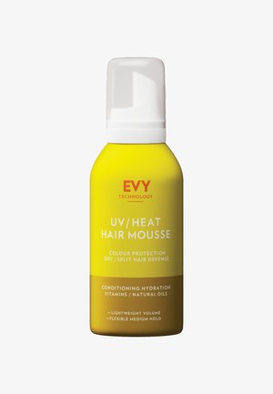 Gelbe Flasche mit EVY Technology UV/Heat Haarmousse, die Texte zu Farbschutz, Hydratation und Styling-Vorteilen enthält.