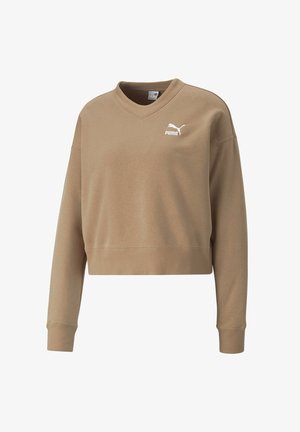 Brązowy skrócony sweatshirt z dekoltem w serek i długimi rękawami. Posiada białe logo Puma na lewej piersi oraz ściągacze przy rękawach i na dole.