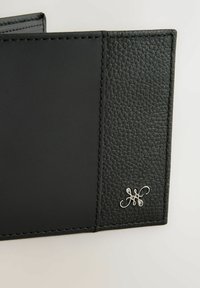 Black leather wallet featuring a textured surface, smooth accents, and silver logo detail on one side. Stitched edges complete the design.