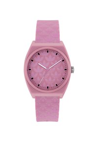 Pink silicone watch with a patterned strap, round case, and matching dial. Black hour markers and hands contrast against a light pink background.