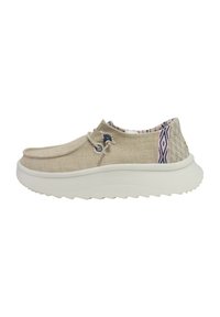 Chaussure slip-on beige avec un dessus en lin texturé, un motif intérieur coloré et une semelle en caoutchouc blanc avec un relief en vagues pour plus de traction.