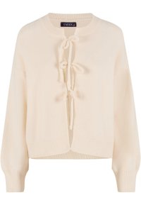 Krémovo sfarbený pletený kardigán s okrúhlym výstrihom, zapínaním na šnúrku vpredu a rebrovanými manžetami. Jemná textúra, športový strih a ľahký dizajn.