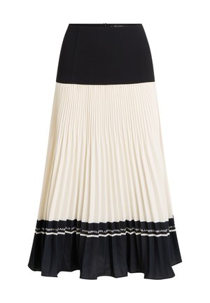 Pleated midi skirt featuring a black top section, cream pleats, and a black ruffled hem with a logo band. Zipper closure at the back.