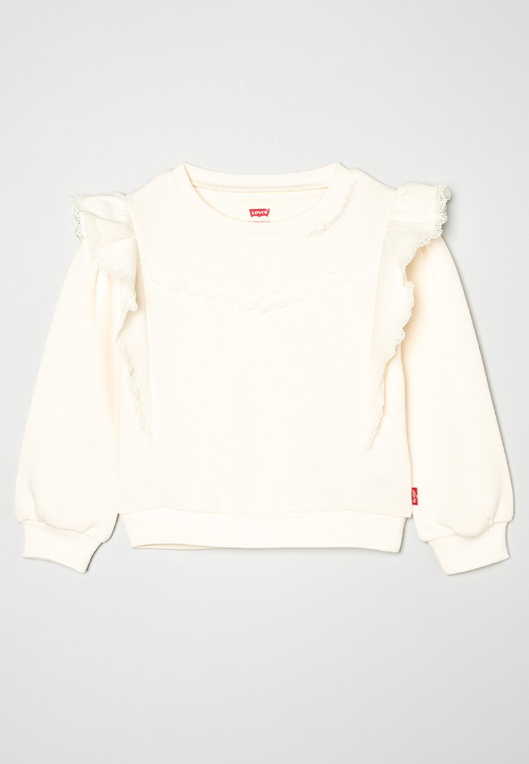 Helles Creme-Sweatshirt mit Rüschensch sleeves und Spitzenverzierungen an der Vorderseite. Gefälschte Bündchen und Saum, lockere Passform. Markenlabel sichtbar.