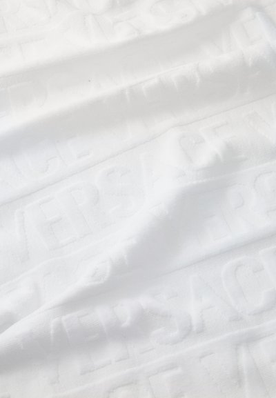 Textil alb cu un branding embossat "VERSACE". Textură netedă cu un luciu subtil, creând un model de suprafață elegant.