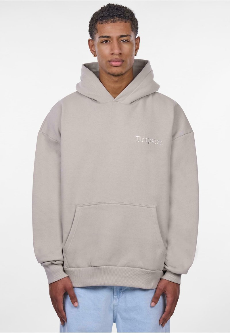 Grauer oversized Hoodie mit einer Fronttasche und Kapuze mit Kordelzug. Mit eingesticktem "Dropsize"-Logo auf der Brust. Weiches Material und Rippbündchen.