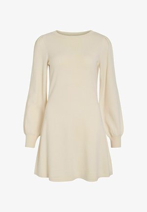 Kremowa sukienka z długim rękawem, okrągłym dekoltem, rozkloszowanym krojem i subtelnymi bufkami. Miękka dzianina o gładkiej fakturze.