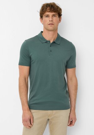 Grünes Baumwoll-Polohemd mit kurzen Ärmeln, Kragen und einer Drei-Knopf-Leiste. Gerippter Saum und Bündchen für einen körperbetonten Look.