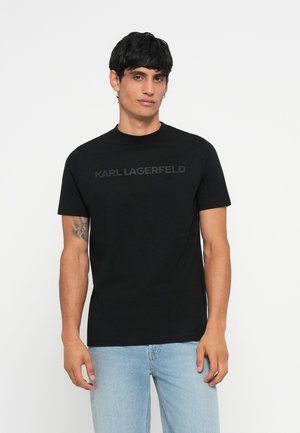 Zwarte katoenen t-shirt met een ronde hals en korte mouwen. 'KARL LAGERFELD' logo in een tonale print over de borst.