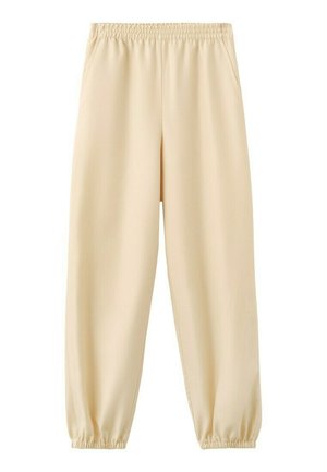 Pantalones jogger beige con cintura y tobillos elásticos, con bolsillos laterales, hechos de tela suave y ligera.