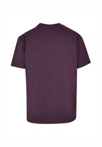 Kortærmet T-shirt i dyb lilla bomuldsstof, med rund halsudskæring og en afslappet pasform. Glat tekstur, ingen grafik eller mønstre.
