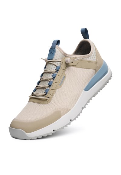 Beige athletic shoe with a textured mesh upper, blue accents, and a unique lacing system. Features a cushioned sole for comfort.