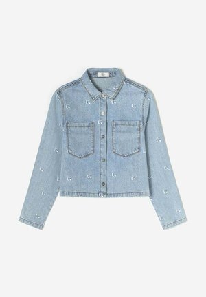 Cropped denim jacket in light blue, featuring a button front, two chest pockets, and small embroidered patterns throughout.