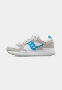 Shoe with a white mesh and beige suede upper, blue accents, gray sole, and a lace-up design featuring circular logo and perforations.