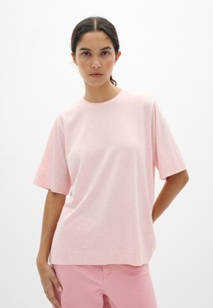 Light pink short-sleeve t-shirt with a crew neckline, made from soft material, featuring a relaxed fit and subtle texture throughout.