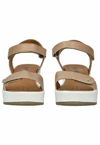 Brown leather sandals with two adjustable straps, embossed accents, and a white platform sole. Textured footbed with perforations for comfort.